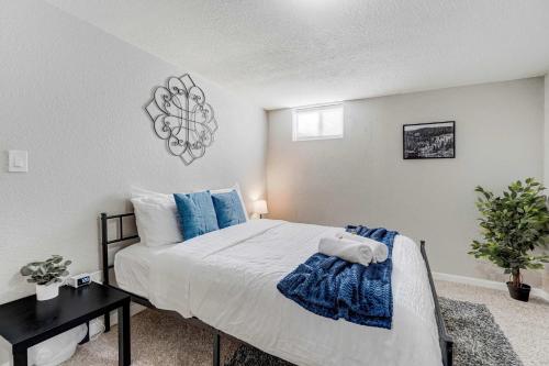 a bedroom with a large bed with blue pillows at Cloud Ridge Cozy Suite w Fire Pit & Game Area in Colorado Springs