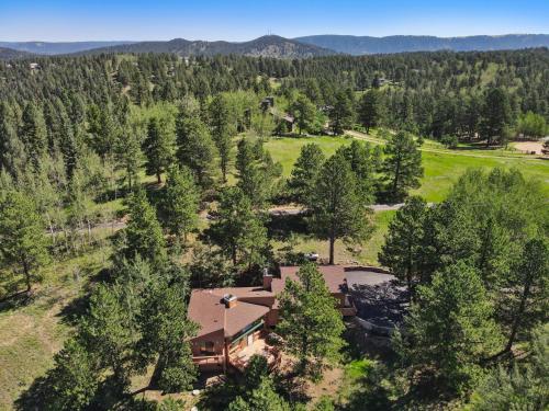 an aerial view of a house surrounded by trees at Multiple Decks, Solarium Sitting Room, Dog Friendly, Office Space in Woodland Park