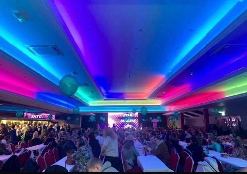 a crowd of people sitting in a room with lights at Willerby, Peppy, Sycamore Walk, Lyons Robin Hood Holiday Park in Rhyl