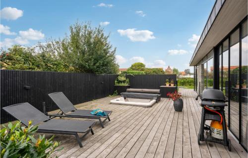 a patio with chairs and a couch and a fence at Four-Bedroom Holiday Home In Juelsminde in Juelsminde