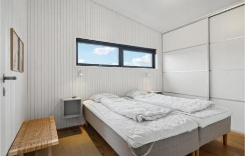 a large bed in a room with a window at Four-Bedroom Holiday Home In Juelsminde in Juelsminde