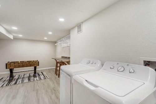 a laundry room with a washing machine and a table at Cloud Ridge Cozy Suite w Fire Pit & Game Area in Colorado Springs
