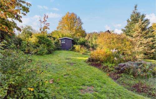 a garden with a small shed in the background at Cozy Home In Bad Wünnenberg With Wifi in Bad Wünnenberg