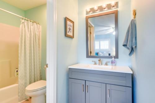a bathroom with a sink and a toilet and a mirror at Golf Getaway with Pool Access Little River Home! in Little River