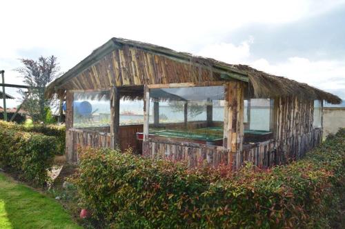 an old wooden building with a window in a field at Cabaña campestre in Cómbita