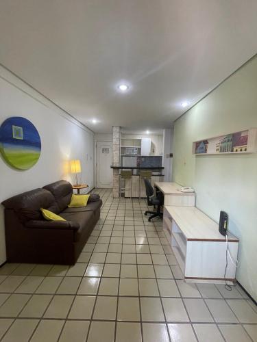 a living room with a couch and a desk at Flat Number One - Fonseca Imóveis in São Luís