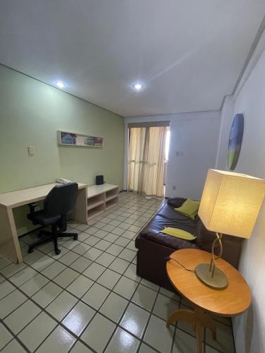 a room with a couch and a desk and a table at Flat Number One - Fonseca Imóveis in São Luís
