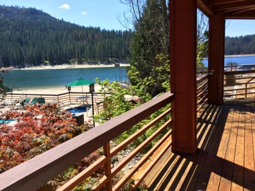 a porch with a view of a beach and the water at The Pines Resort & Conference Center in Bass Lake
