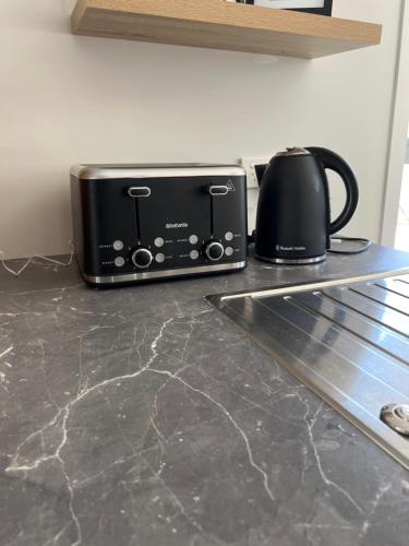 a toaster oven sitting on top of a kitchen counter at Homestay with Saana in Pukekohe East