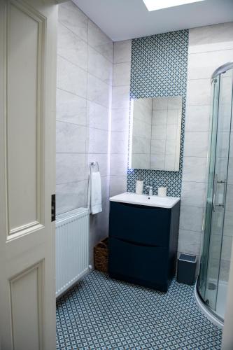 a bathroom with a sink and a mirror at Luxurious 5Star Retreat on Westports Main Street in Westport