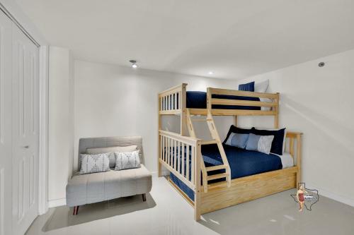 a bedroom with a bunk bed and a chair at Bahia Mar-Solare Tower, Beachfront Resort with Two Pools in South Padre Island