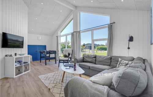 a living room with a couch and a table at Stunning Home In Hadsund With Five Bedrooms And Wifi in Hadsund