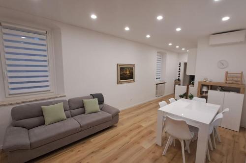 a living room with a couch and a table at Casa La Bisbetica in San Damiano dʼAsti