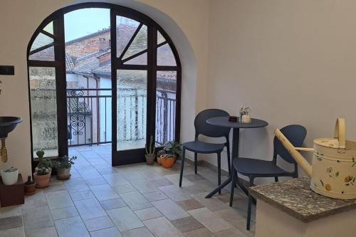 a room with a table and chairs and a window at Casa La Bisbetica in San Damiano dʼAsti