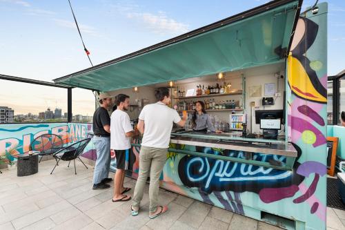 a group of people standing around a food truck at YHA Brisbane City in Brisbane