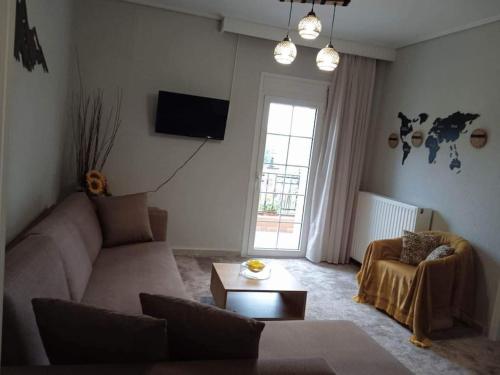a living room with a couch and a tv at Chrysoula's home -koziakas- PYLI in Pýli