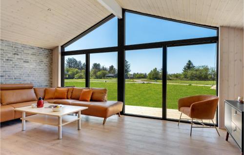 a living room with a couch and a table at Beautiful Home In Hjørring With Sauna in Hjørring