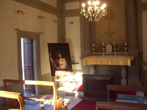 a living room with a painting of a woman on the wall at Castello di Mugnana in Mugnana