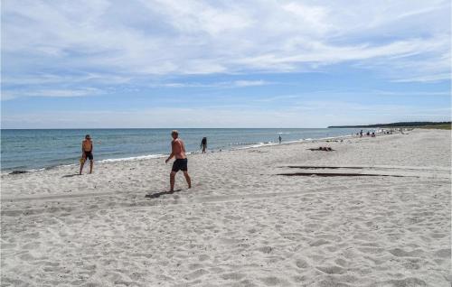 a group of people walking on the beach at Amazing Home In Grenaa With Wifi in Grenå
