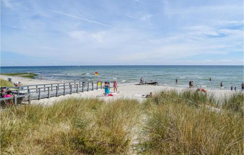 a group of people on a beach near the ocean at Amazing Home In Grenaa With Wifi in Grenå