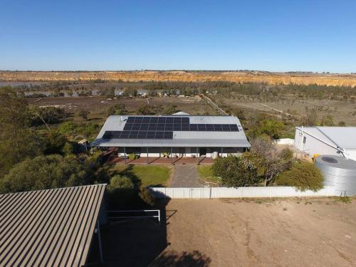 an aerial view of a building with solar panels at Wongulla Heights in Wongulla