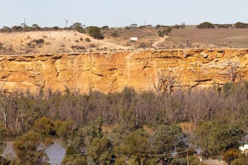a view of a cliff with a river and trees at Wongulla Heights in Wongulla