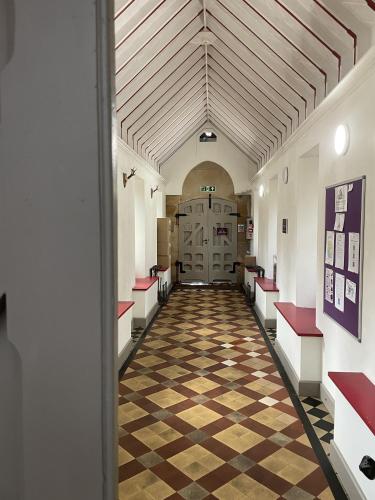 a hallway of a building with a checkered floor at The Classrooms, Loch Ness Abbey - 142m2 Lifestyle & Heritage apartment - Pool & Spa - The Highland Club - Resort on lake shores in Fort Augustus