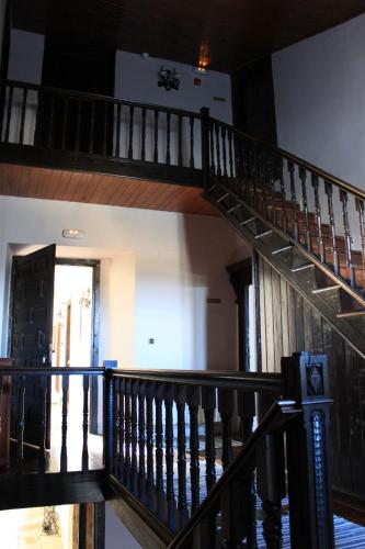 a spiral staircase in a house with a hallway at Pazo Torre Do Barrio in Loseiro