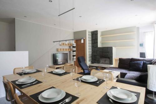 a living room with a table and chairs and a couch at Appartements Christophorus in Bad Hofgastein