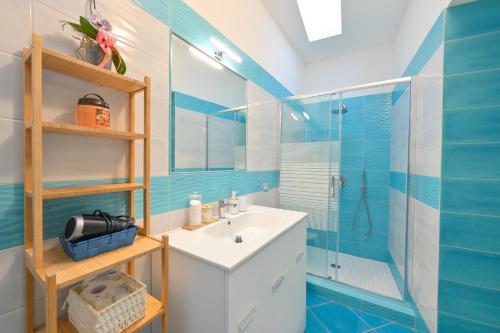 a bathroom with a sink and a shower at Chiaia Di Rose Rooms & Apartment in Ischia