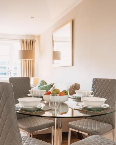 a dining room with a table with bowls of fruit on it at St Leonard's Luxury Lodge, St Andrews in St. Andrews