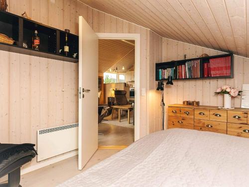 a bedroom with a bed and a room with a desk at 8 person holiday home in Bogense-By Traum in Bogense