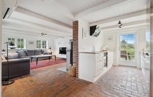 a living room with a couch and a table at Lovely Home In Ringkøbing With Wifi in Søndervig