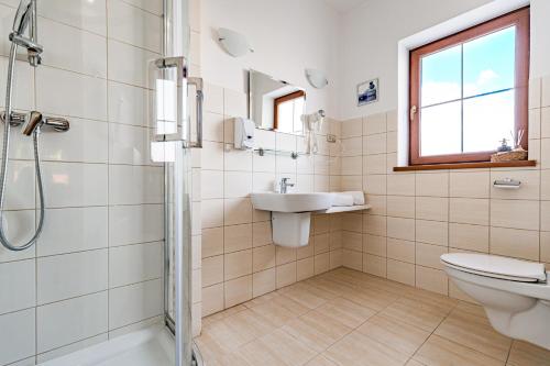 a bathroom with a sink and a toilet and a shower at Zajazd Żuławy - Restauracja & Hotel in Elblag