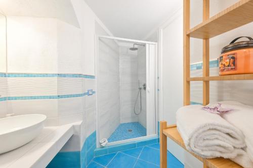 a bathroom with a shower and a sink at Chiaia Di Rose Rooms & Apartment in Ischia