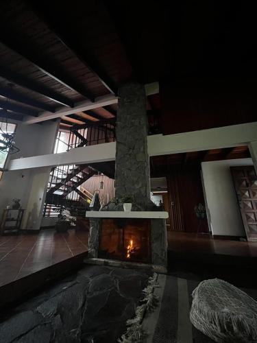 a living room with a fireplace in a building at Casa Aldaba in San José