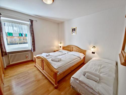 Postel nebo postele na pokoji v ubytování Rossetti 3 camere by AMA Val di Fassa