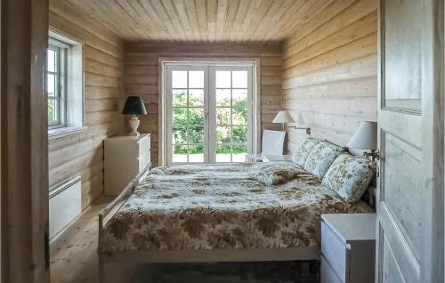 a bedroom with a bed and a window at Holiday Home Katholm in Ålsrode