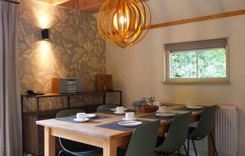 a dining room with a wooden table and chairs at Hawar in De Bult