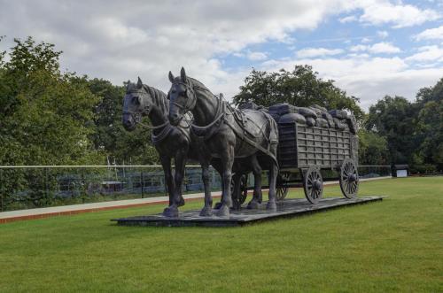 a statue of two horses pulling a wagon at Frensham Pond Country House Hotel & Spa in Farnham