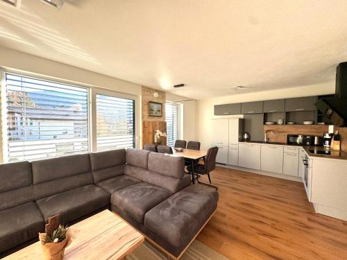 a living room with a couch and a table at Alpin Apartments in Radstadt