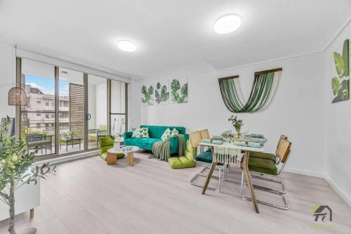 a living room with a couch and a table at Utopia 2B2B in Wentworth Point&Olympic Park in Sydney