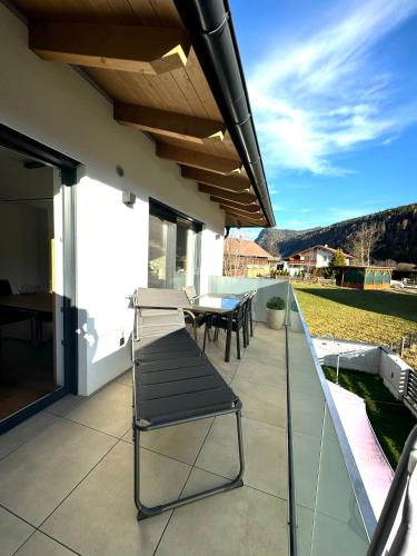 a patio with a table and a bench on a house at Alpin Apartments in Radstadt