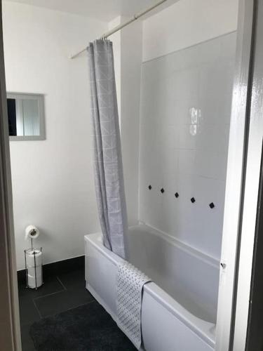 a white bathroom with a tub and a shower at Spacious Property For Hols Base & Contractors Long or Short Stays C2C Western Lakes in Cleator Moor