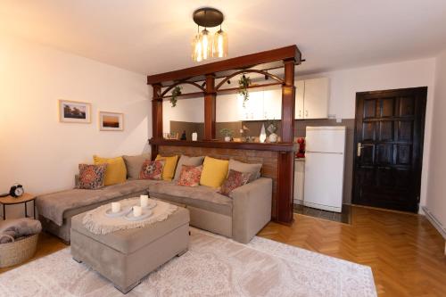 a living room with a couch and a table at Vila Bonsai Golija in Golija