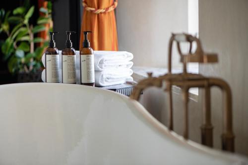 three bottles of wine sitting on a table with towels at Fairmont Tazi Palace Tangier in Tangier
