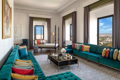 a living room with a green couch and a table at Fairmont Tazi Palace Tangier in Tangier