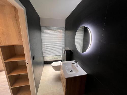 a bathroom with a white sink and a mirror at Hotel Parkzicht in Valkenburg