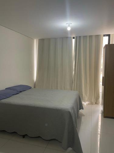 a bedroom with a bed and a window at Residencial bella vista haus in Cabedelo