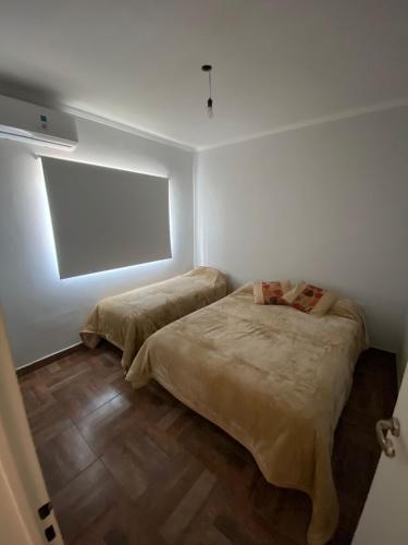 a bedroom with two beds and a projection screen at El Despertar in Concepción del Uruguay